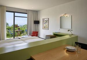 a hotel room with a large bed and a table at Leivatho Hotel in Svoronata