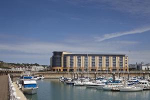 a bunch of boats docked in a harbor with a building at Radisson Blu Waterfront Hotel, Jersey in Saint Helier Jersey