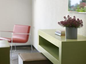 a desk with a vase of flowers and a chair at Leivatho Hotel in Svoronata