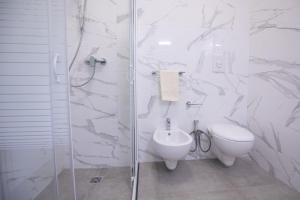 a white bathroom with a toilet and a shower at Villa Antonietta in Carovigno +22 photos
