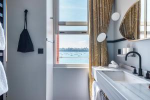 a bathroom with a sink and a window at Castelbrac Hotel & Spa in Dinard