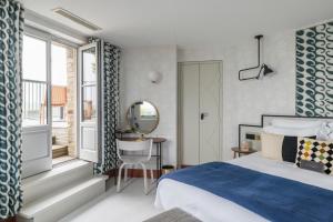 a hotel room with a bed and a window at Castelbrac Hotel & Spa in Dinard