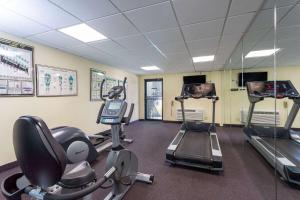 a gym with treadmills and elliptical machines at Ramada by Wyndham Altamonte Springs Near I-4 in Orlando