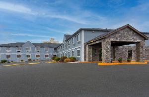 a large building with a parking lot in front of it at Super 8 by Wyndham Somerset in Somerset