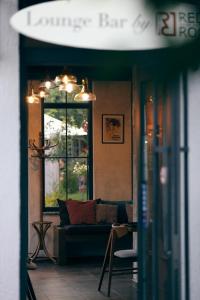 a living room with a couch and a table at REDROOF country house hotel in Goris