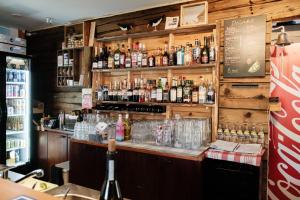 a bar with a lot of bottles of alcohol at Bed & Breakfast Restaurang Sybarit in Houtskari