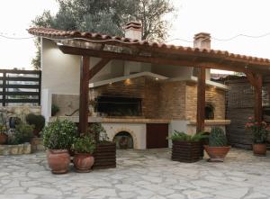 a house with a patio with pots of plants at Athena Home South Crete in Kapparianá