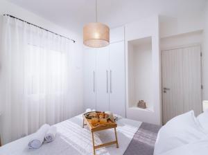 a bedroom with a bed and a table with towels at Athena Home South Crete in Kapparianá