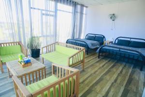 a hospital room with three beds and a table at Ventosa Homefarm Măng Đen in Kon Von Kla