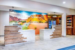 a lobby of a mountain store with a mural on the wall at La Quinta by Wyndham St. George in St. George