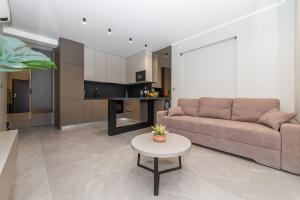a living room with a couch and a table at Apartments Oliv'e with jacuzzi in Novalja