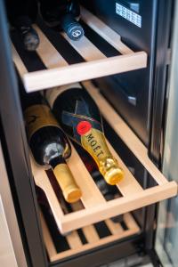 a bottle of wine inside of a refrigerator at Apartments Oliv'e with jacuzzi in Novalja
