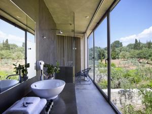 a bathroom with two sinks and a large window at Leivatho Hotel in Svoronata