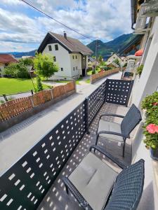 a balcony with two chairs and a table at Charming Bella Hideout - Adults Only in Jesenice