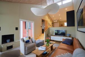 a living room with a couch and a tv at Barsebäck Resort Hotell in Löddeköpinge