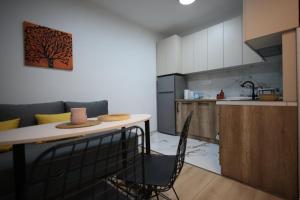 a kitchen with a table and chairs in a room at Enjoy Apartments Prilep in Prilep