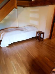 a bedroom with a bed and a wooden floor at Maison de 3 chambres avec jardin amenage et wifi a Taintrux in Taintrux