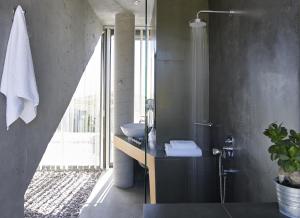 a bathroom with a sink and a toilet in a room at Leivatho Hotel in Svoronata