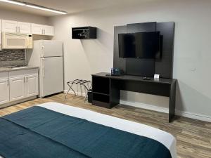 a room with a bed and a desk with a television at Motel 6 Las Vegas NV Downtown Fremont St in Las Vegas