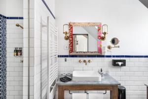 a bathroom with a sink and a mirror at Maison Bistro & Hotel in Budapest +105 photos