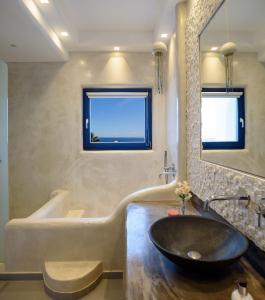 a bathroom with a sink and a tub and a mirror at Beautiful Santorini Villa 3 Bedrooms Villa Phos Private Pool & Lovely Sea View Exo Gialos in Karterados