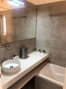 a bathroom with a sink and a toilet and a tub at Casa do Poço in Burgau