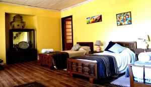 a bedroom with a bed and a couch at Casona Re-encuentro in Yerbas Buenas