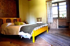 1 dormitorio con 1 cama en una habitación con ventana en Casona Re-encuentro, en Yerbas Buenas