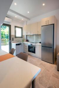 a large kitchen with a stainless steel refrigerator at PARGA 4 SEASONS VILLAS in Parga