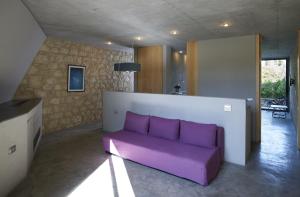 a purple couch sitting in a living room at Leivatho Hotel in Svoronata