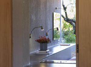 a bathroom with two sinks and two lamps on a counter at Leivatho Hotel in Svoronata