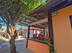 an outside view of a house with a pergola at Patar White Beach Bolinao- LILYBETH TRANSIENT HOUSE 1 # -NOT Beachfront in Bolinao
