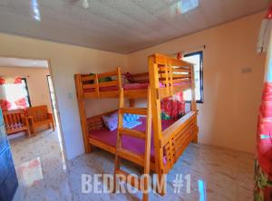 a bedroom with bunk beds in a room at Patar White Beach Bolinao- Lilybeth's Transient House in Bolinao
