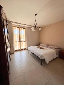 a bedroom with a bed and a large window at Cà di Gat in La Morra