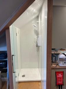 a shower with a glass door in a bathroom at Inviting 1-Bed Studio in Pitlochry in Pitlochry