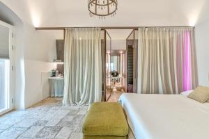 a bedroom with a large bed and a large window at Arya Nobile Dimora in Carovigno +37 photos