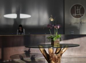 a table with a vase of flowers on top of it at Leivatho Hotel in Svoronata