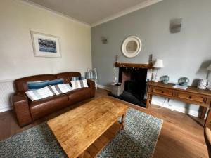 a living room with a couch and a coffee table at Kirkmay House in Crail