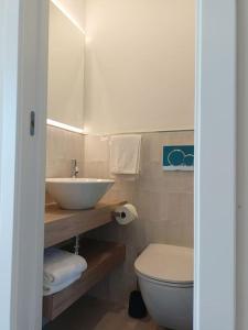 a bathroom with a sink and a toilet at Stanza Mylai Etna View in Castelmola