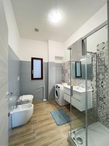 a bathroom with two sinks and a tub and a shower at Villa Cecita Holiday in Sellia Marina