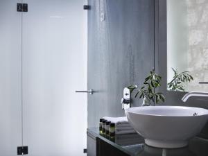 a bathroom with a white bowl sink on a counter at Leivatho Hotel in Svoronata