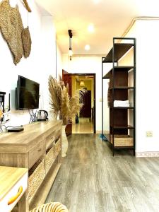 a living room with a wooden floor and a shelf at Emerald Boutique Stay in Can Tho