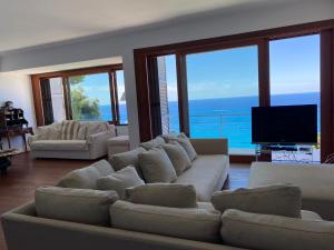a living room with a couch and a television at Camogli - "Casa Oliver" - Liguria Holidays in Camogli