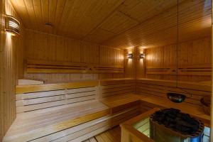 a wooden sauna with a bucket in it at Hotel DUKAT in Gura Humorului