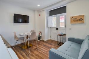 a living room with a couch and a table at Bonneville Setúbal I, By Home Match in Setúbal