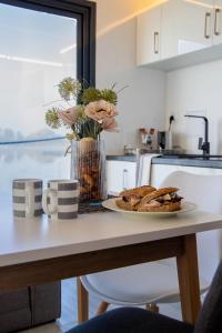 a kitchen counter with a plate of food on a table at Hausboat David in Hrdoňov