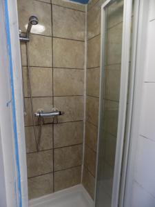 a shower with a glass door in a bathroom at The Phoenix Hostel in London