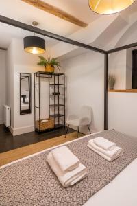 a bedroom with a bed with two towels on it at Stunning 3 Bedroom Duplex with Terrace in Brighton & Hove