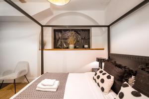 1 dormitorio con 1 cama en blanco y negro y 1 silla en Stunning 3 Bedroom Duplex with Terrace en Brighton & Hove