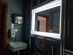 a bathroom with a sink and a mirror at Castle Lodge - Brecon Beacons Accommodation in Sennybridge +15 photos